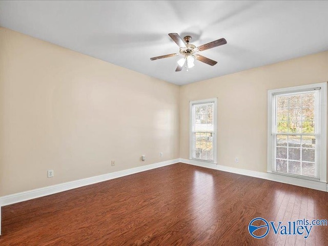 empty room with hardwood / wood-style floors and ceiling fan