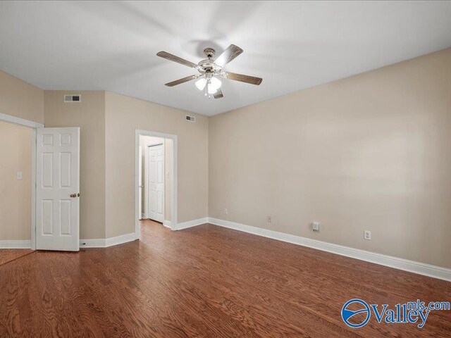 unfurnished room with ceiling fan and dark hardwood / wood-style floors