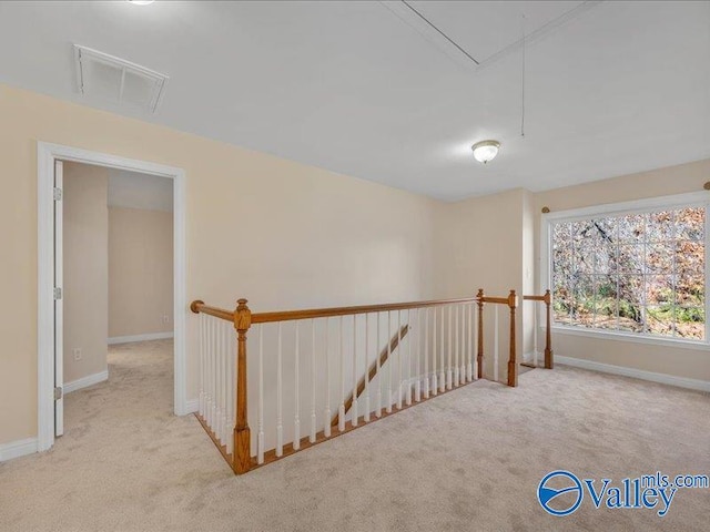 hallway with light colored carpet