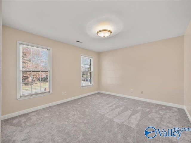 unfurnished room with light colored carpet