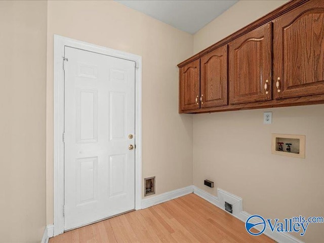 laundry room featuring cabinets, hookup for a washing machine, light hardwood / wood-style flooring, and electric dryer hookup