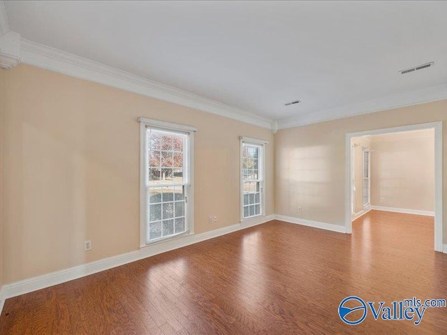 unfurnished room with hardwood / wood-style floors and ornamental molding