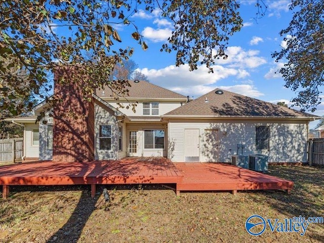 back of property featuring a wooden deck and cooling unit