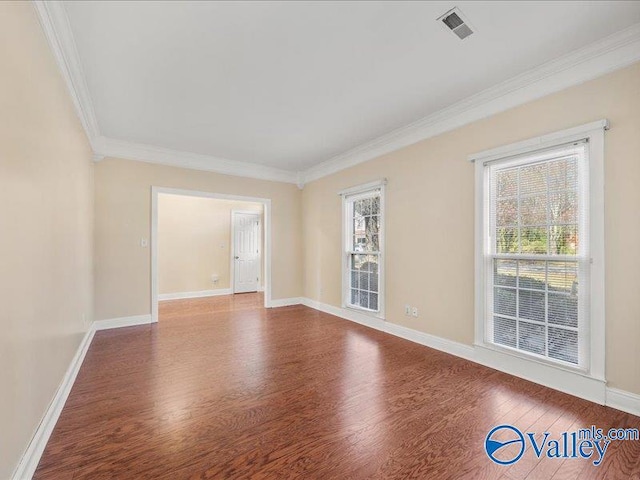 unfurnished room with hardwood / wood-style flooring and crown molding