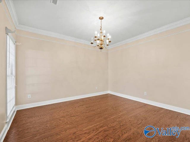 spare room with hardwood / wood-style floors, an inviting chandelier, and crown molding