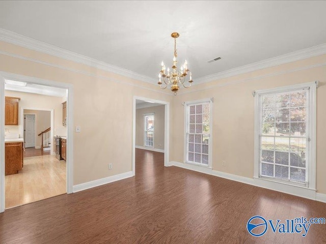 interior space featuring ornamental molding, dark hardwood / wood-style flooring, and a notable chandelier