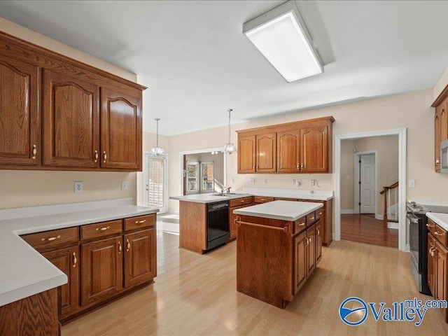 kitchen featuring stainless steel electric range oven, pendant lighting, black dishwasher, light hardwood / wood-style floors, and a kitchen island