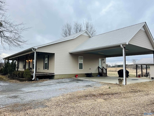 view of home's exterior featuring a carport and a porch