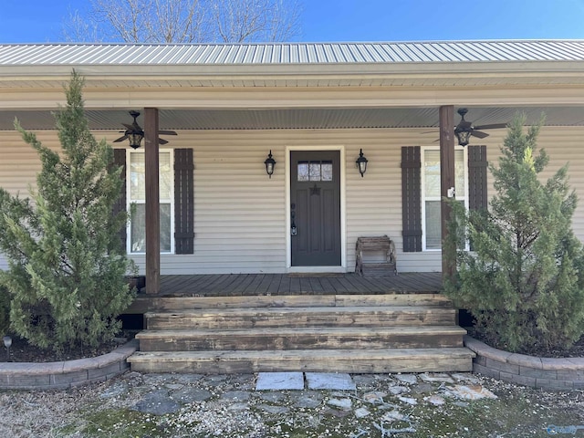 doorway to property featuring covered porch and ceiling fan