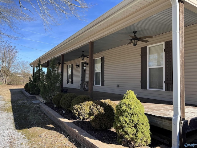 view of side of property with covered porch and ceiling fan