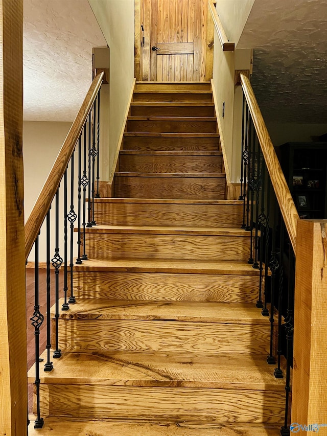 staircase featuring wood finished floors