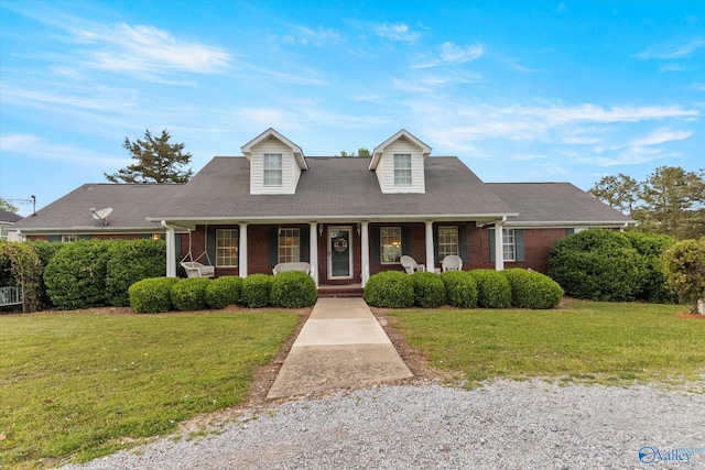 cape cod-style house with a porch and a front yard