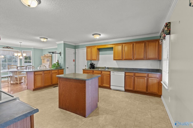 kitchen featuring pendant lighting, dishwasher, sink, and a kitchen island