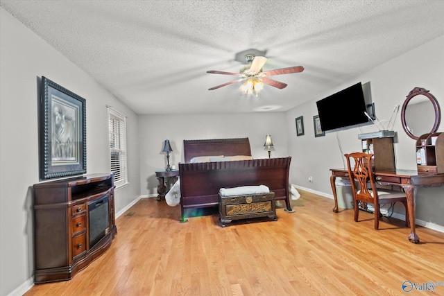 bedroom with light hardwood / wood-style flooring and a textured ceiling