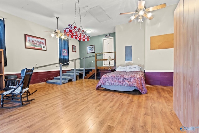 bedroom featuring electric panel and light hardwood / wood-style flooring