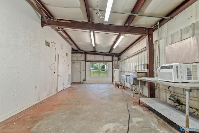 miscellaneous room featuring concrete flooring, gas water heater, and cooling unit