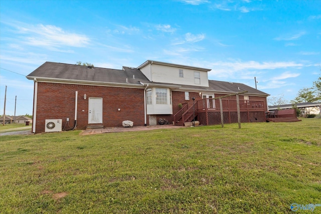 rear view of property with a wooden deck, a yard, and ac unit