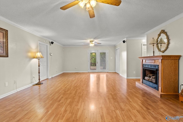 unfurnished living room featuring light wood-type flooring, ceiling fan, crown molding, a textured ceiling, and french doors