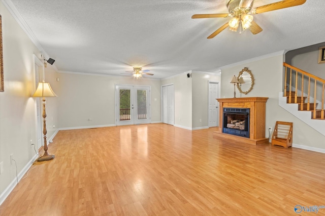 unfurnished living room featuring crown molding, ceiling fan, a textured ceiling, and light wood-type flooring