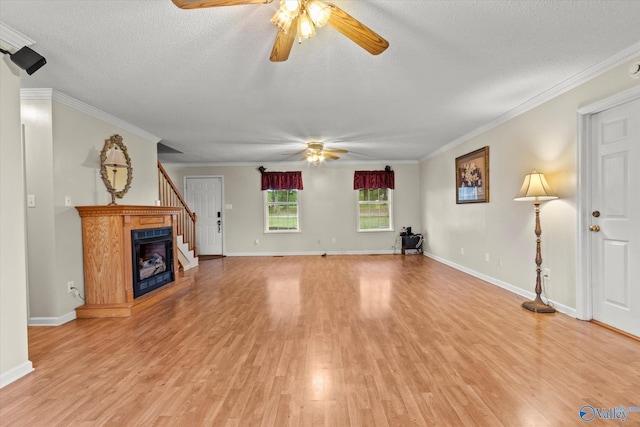 unfurnished living room featuring ceiling fan, crown molding, light hardwood / wood-style flooring, and a textured ceiling