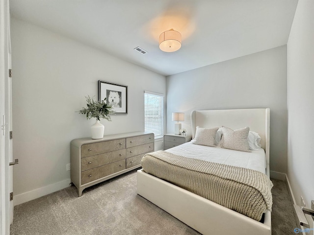 bedroom with light colored carpet, visible vents, and baseboards