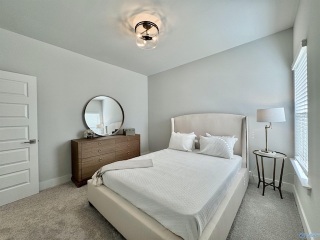 bedroom featuring baseboards and carpet floors