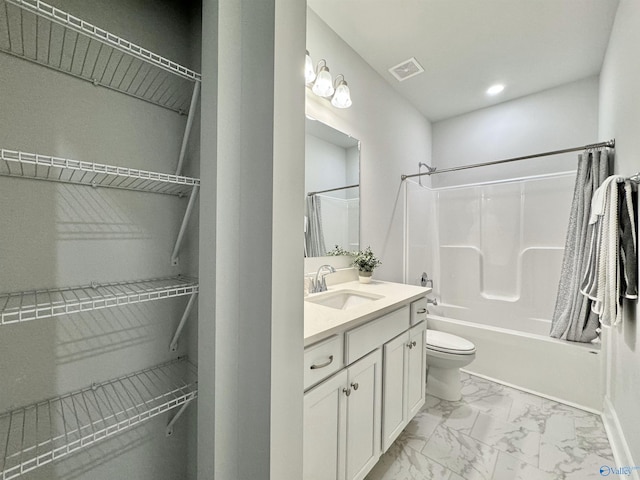 bathroom featuring visible vents, toilet, marble finish floor, washtub / shower combination, and vanity