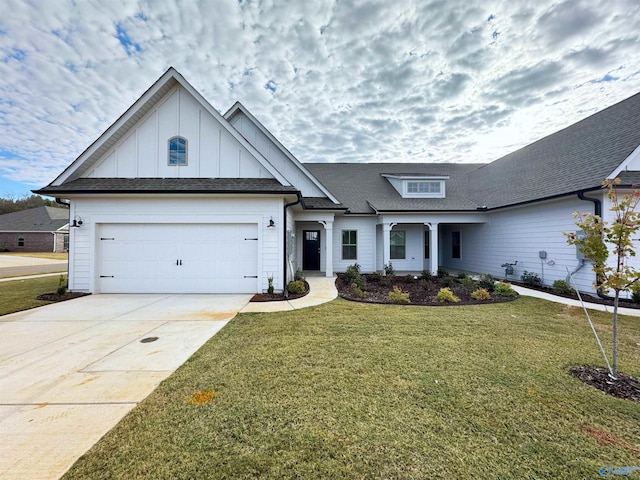 view of front of property with board and batten siding, a front lawn, roof with shingles, driveway, and an attached garage