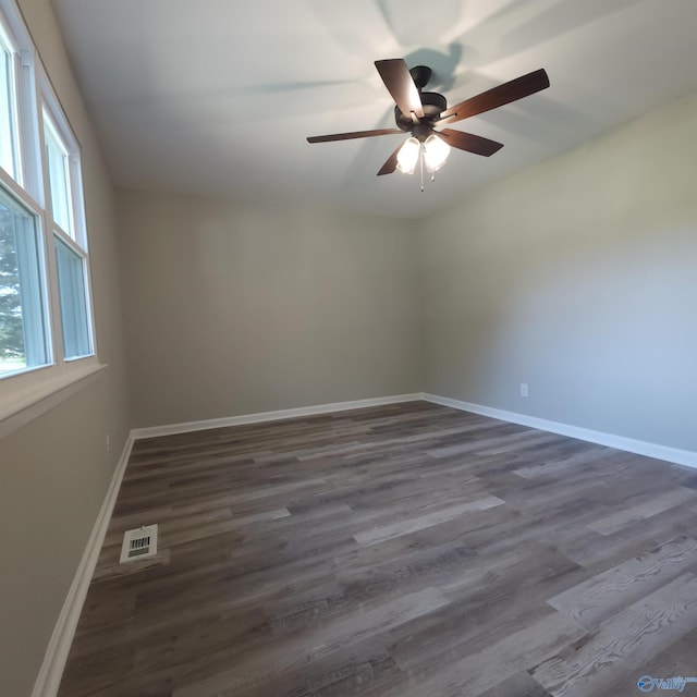 spare room with ceiling fan and dark hardwood / wood-style floors