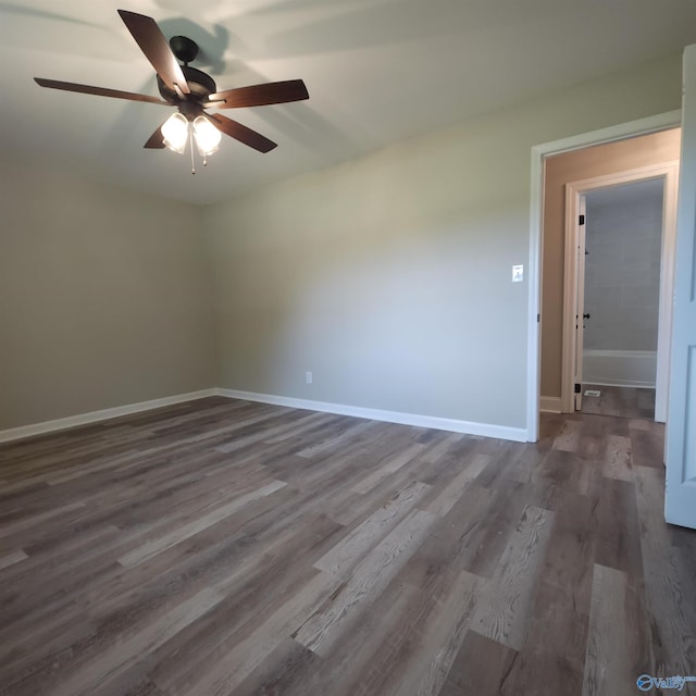 empty room featuring dark wood-type flooring and ceiling fan