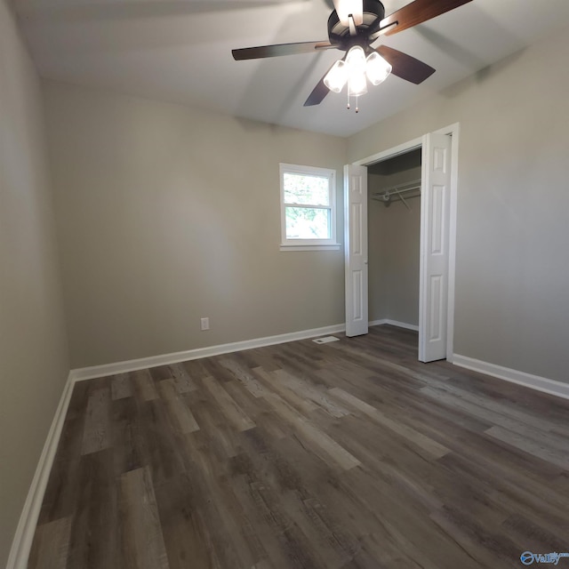 unfurnished bedroom featuring a closet, ceiling fan, and dark hardwood / wood-style floors