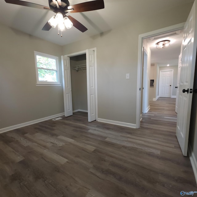 unfurnished bedroom with a closet, ceiling fan, and dark hardwood / wood-style flooring