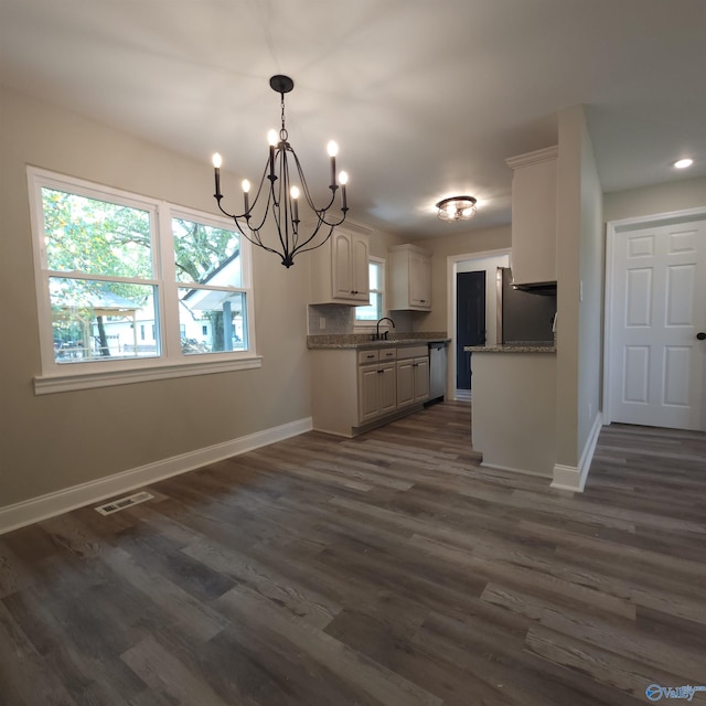 kitchen featuring hanging light fixtures, an inviting chandelier, stone countertops, white cabinetry, and dark hardwood / wood-style floors