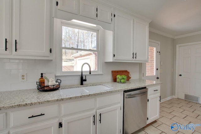 kitchen featuring tasteful backsplash, white cabinets, dishwasher, crown molding, and a sink