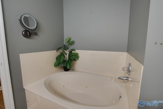 bathroom with a tub with jets