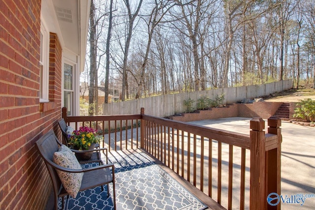 wooden deck featuring a patio area and a fenced backyard