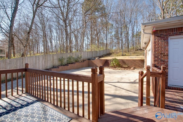 wooden deck with a patio area and fence