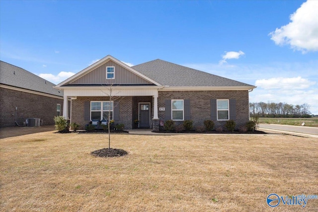 craftsman-style house featuring central AC and a front lawn