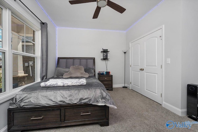 carpeted bedroom featuring multiple windows, ceiling fan, and ornamental molding