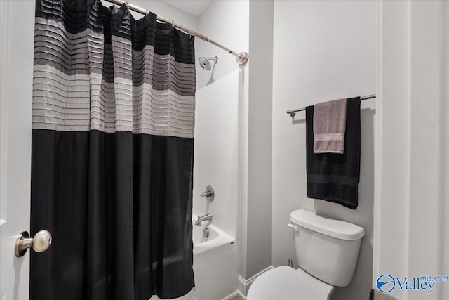 bathroom featuring shower / bath combination with curtain and toilet