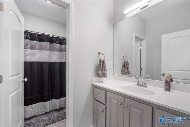 bathroom with tile patterned floors and vanity