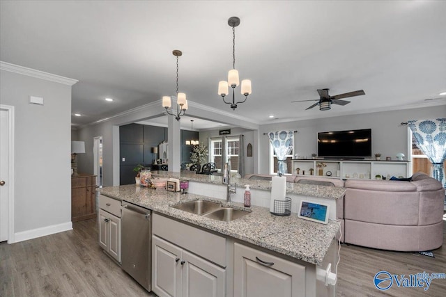 kitchen with a center island with sink, stainless steel dishwasher, plenty of natural light, and light hardwood / wood-style floors