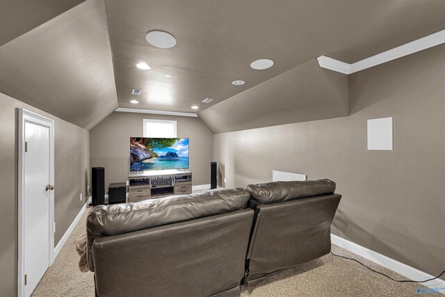 home theater room with vaulted ceiling and carpet flooring