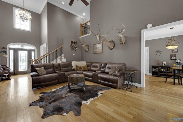 living room featuring plenty of natural light, crown molding, and light hardwood / wood-style floors