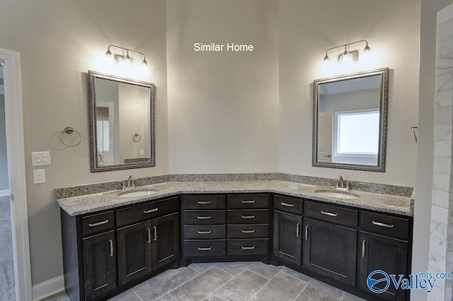 full bath with double vanity and a sink