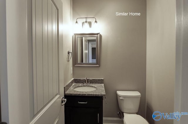 bathroom featuring toilet and vanity