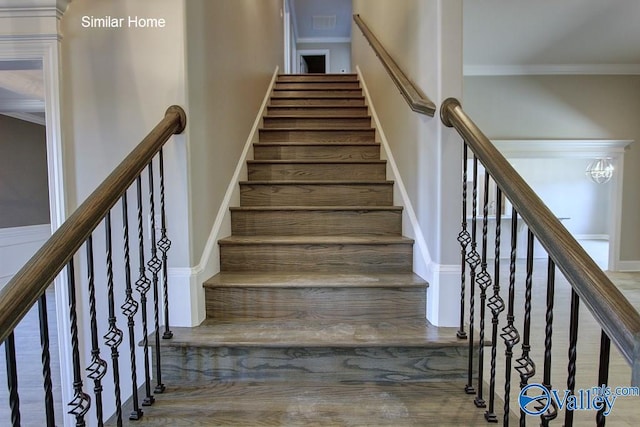 staircase featuring baseboards and ornamental molding