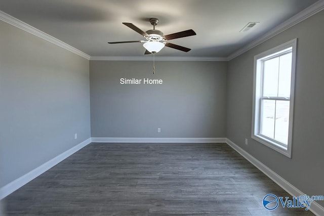 spare room with a ceiling fan, dark wood-style floors, visible vents, baseboards, and crown molding