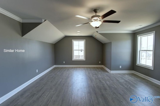 bonus room featuring a ceiling fan, baseboards, visible vents, lofted ceiling, and dark wood-style flooring