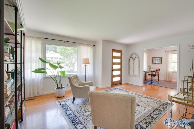 living room with baseboards, wood finished floors, and visible vents